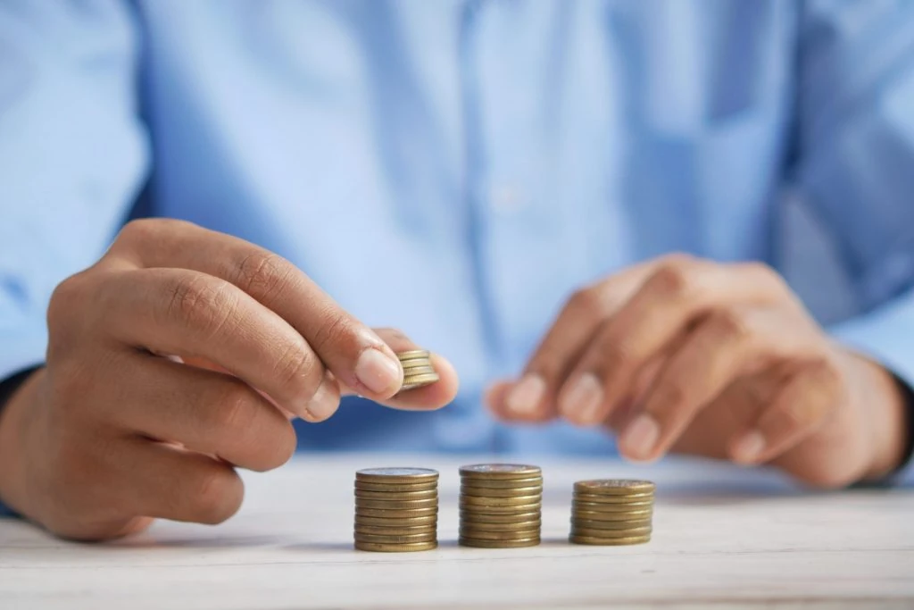 man counting coins scaled